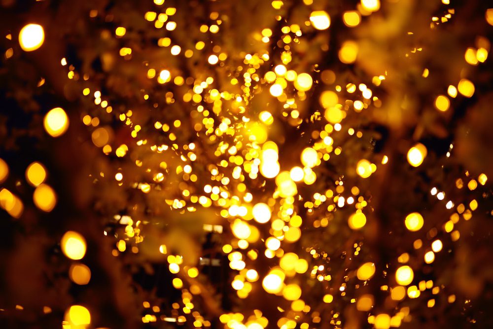 Abstract golden bokeh lights in dark background